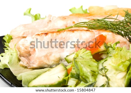 Stake from a salmon with vegetables on a plate. Closeup.