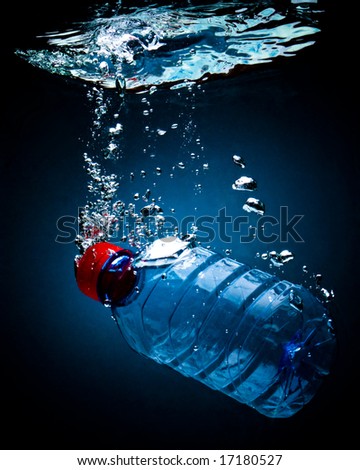 Bottled water on a black/blue background with air bubbles
