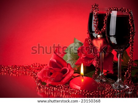 two glasses of wine. stock photo : Two glasses of wine, rose and heart on a red background.