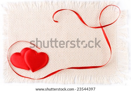 Two hearts and red tape on a canvas. Valentines day card.