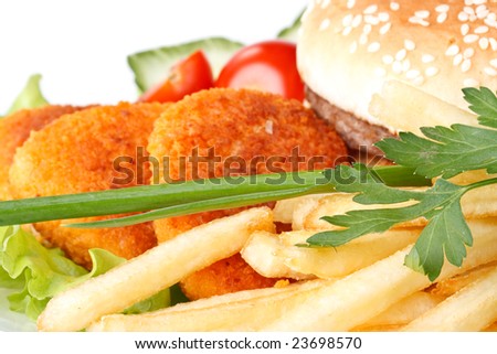 Hamburger, french fries, chicken nuggets, and vegetables on a white background