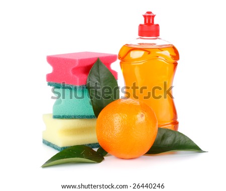 Household washing-up liquid, sponges and fresh orange with leaves on a white background