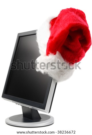 Modern flat screen LCD monitor in a Santa\'s cap on a white background.