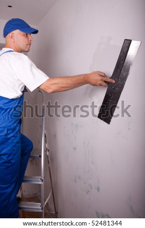 Male builder makes repairs in the apartment