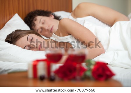 Happy young family sleep in the bed at home. Valentine\'s Day.
