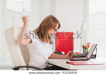 Stressed  business woman with  laptop in the office.