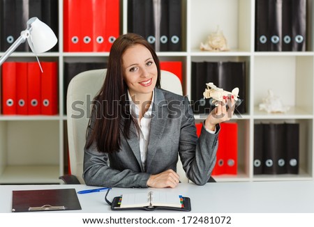 Businesswoman With A Model Of Plane Sits On A Workplace In The Office. Travel Agency.