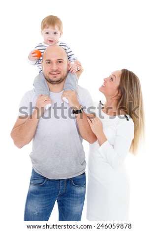 Young parents with their  sweet  child stand on a white background. Happy family.