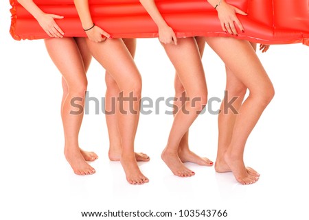 Picture of four women covering their body with a red mattress over white background