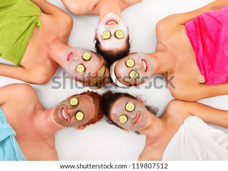 A Picture Of Five Girl Friends Relaxing With Facial Masks On Over White Background
