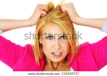 A picture of a young depressed woman tearing out her hair over white background - stock photo