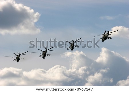 five military helicopters flying during air show