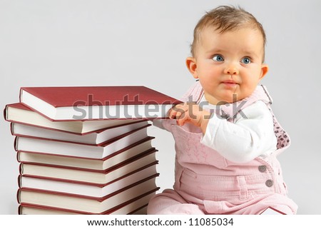 small baby girl and many red books with red cover