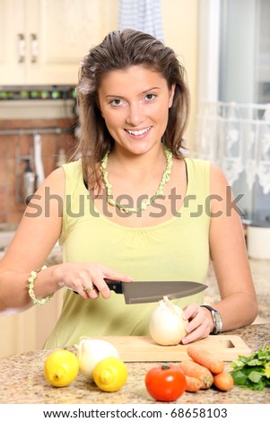 A portrait of a young beautiful wife working in the modern kitchen