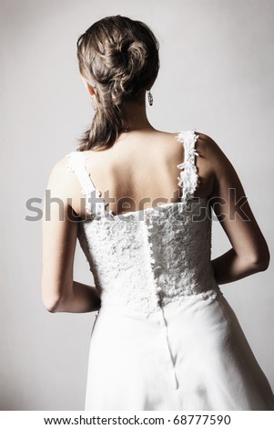 A picture of the back of the bride over grey background