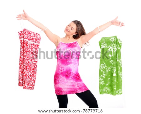 A portrait of a happy woman trying to decide between three dresses over white background