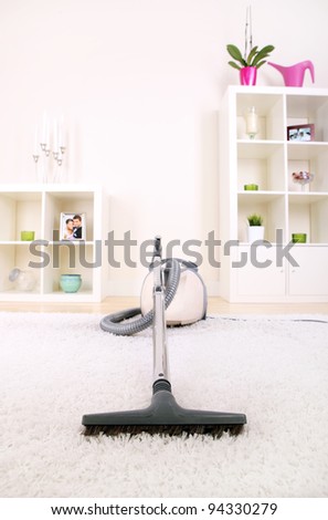 A picture of a new vacuum cleaner standing in the living room