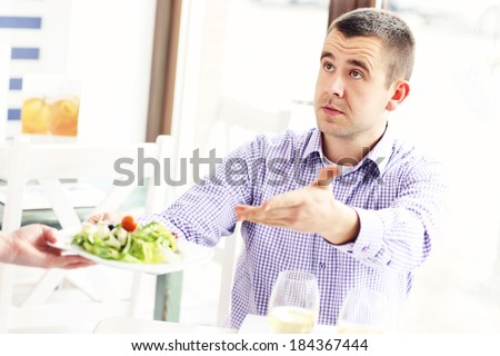 A picture of a customer complaining about the food in a restaurant