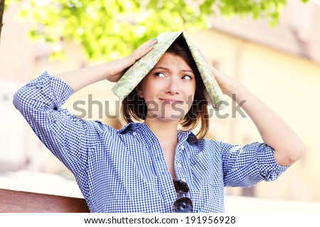 A picture of a lost tourist with a map in a town