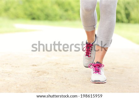 A picture of jogger\'s legs on the path in the park
