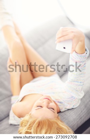 A picture of a sexy woman lying on sofa and taking selfie