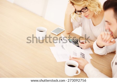 A picture of an adult couple working on documents at home