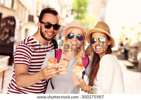 A picture of a group of friends eating ice-cream in the city