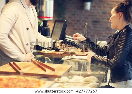 Picture of woman paying by credit card in restaurant