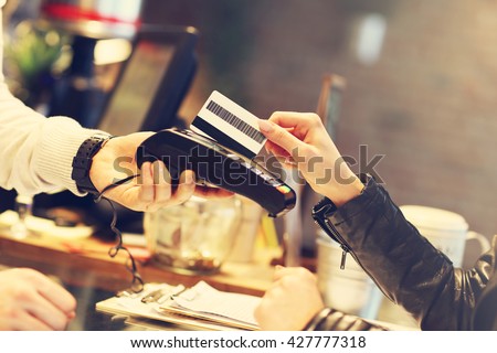 Picture of woman paying by credit card in restaurant