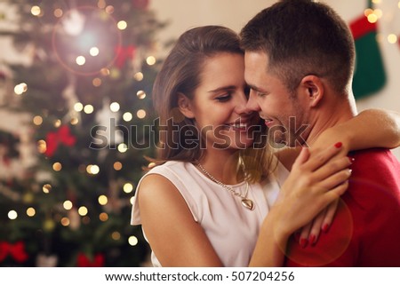 Picture of young couple hugging in Christmas time