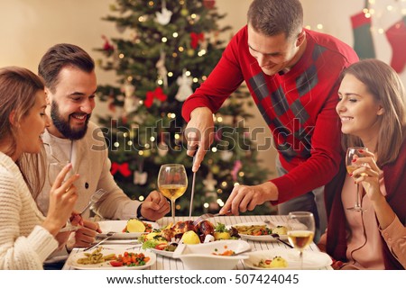 Picture showing group of friends celebrating Christmas at home