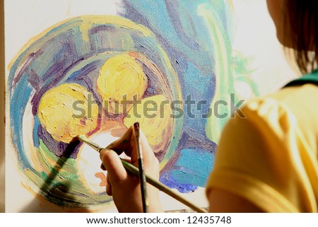Young woman painting still life composition