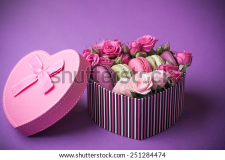 present box heart shape with flowers and macaroons violet background for valentines mother day easter with love