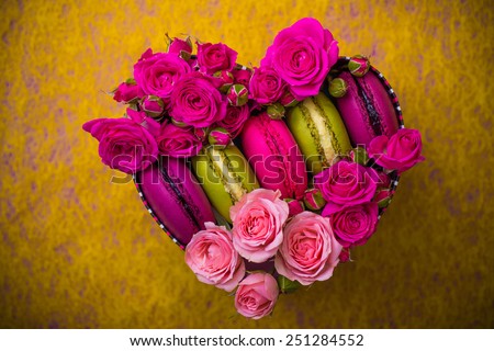 present box heart shape with flowers and macaroons yellow background for valentines mother day easter with love