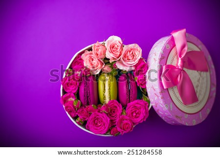 present box with flowers and macaroons violet background