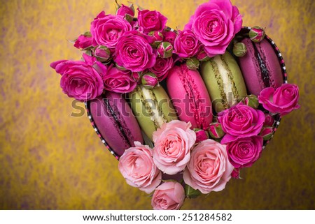 present box heart shape with flowers and macaroons food yellow background for valentines mother woman day easter with love