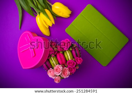 present box heart shape with flowers tulips macaroons and tablet violet background for valentines mother woman day easter with love
