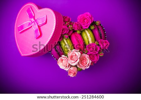 present box heart shape with flowers and macaroons violet background for valentines mother day easter with love