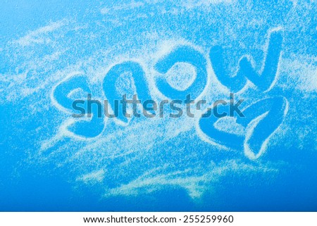 word snow on blue background written on the white snow