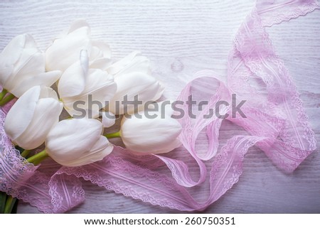 spring flowers white tulips bouquet on wooden background with lace ribbon present for holidays mother day easter valentines