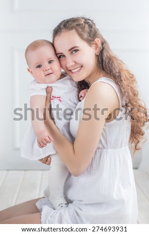 family portrait mother and daughter kissing and hugging white background