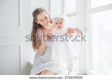 family portrait mother and daughter kissing and hugging white background