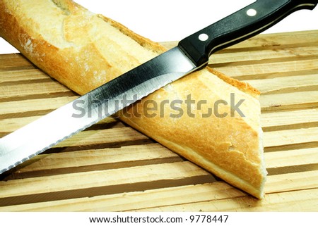 French Bread With Knife On Breadboard