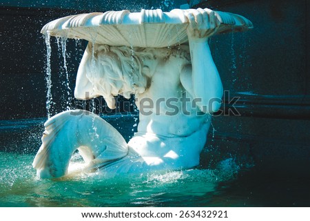 Statue of white stone in fountain situated near house of Parliament, Vienna.Austria.