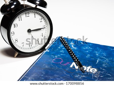 Concept image of memory time, time to study or business time to show by alarm clock, book and pen