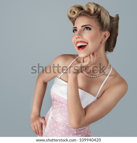 Classic retro style fashion portrait of young blonde pin-up girl studio shot