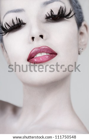 Young beautiful fashion model with creative makeup close-up portrait