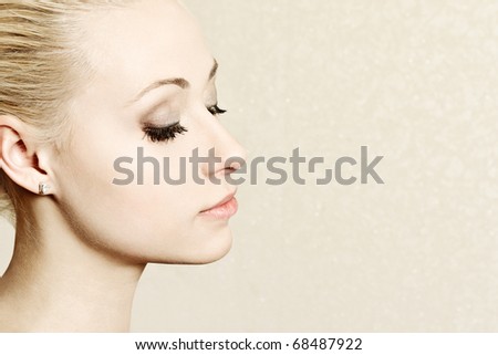 Beautiful young blond woman face profile portrait