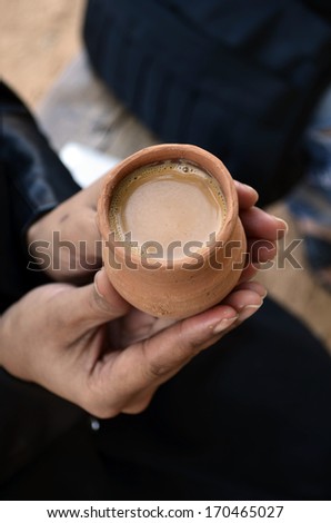 Female hand with cup of tea , offering tea to relax, background with lot of space for message, good morning tea