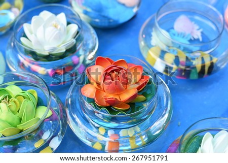 Bright and beautiful colors of plastic flowers in blue light setting
